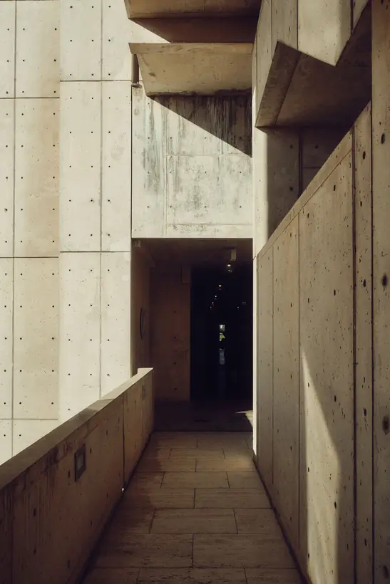 Brutalist covered walkway in board-marked concrete