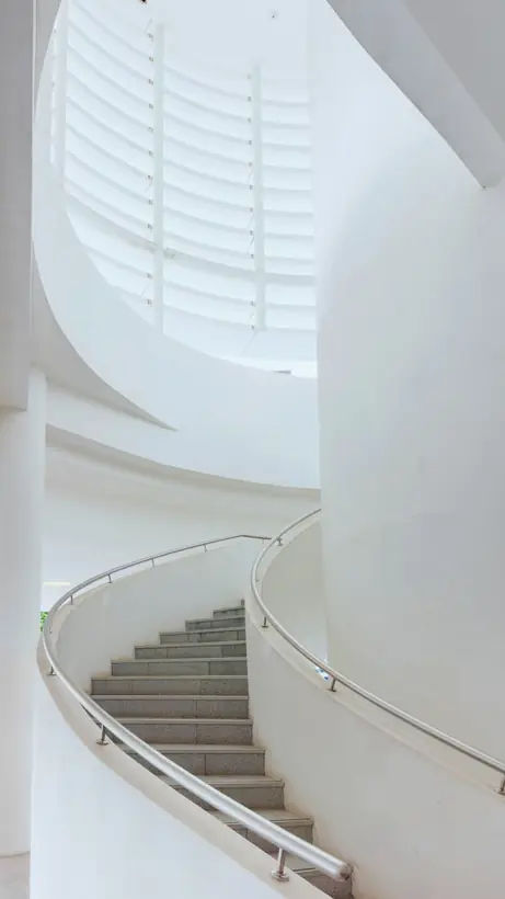 Curved stair, white plaster